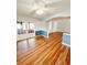 Open living room with hardwood floors, French doors to the outside, and fresh paint at 1603 Gaston Foster Rd, Orlando, FL 32812