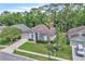 Aerial view showcases a well-manicured lawn, lush greenery, and mature trees surrounding the home at 1610 River Birch Ave, Oviedo, FL 32765