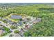 High aerial view of a neighborhood with a lake nearby; the property is marked with a red pin at 1610 River Birch Ave, Oviedo, FL 32765