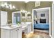 Dual sink bathroom showcasing stylish vanities, with a doorway view of the primary bedroom at 1610 River Birch Ave, Oviedo, FL 32765