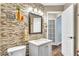 Bathroom features a single sink, mosaic tile accents, and stylish decor at 1610 River Birch Ave, Oviedo, FL 32765