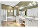 Bathroom with double sink vanity, soaking tub, separate shower, and stylish light fixtures at 1610 River Birch Ave, Oviedo, FL 32765
