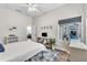 Bedroom with ceiling fan, desk area, and view of outdoor living space at 1610 River Birch Ave, Oviedo, FL 32765