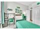 Well-lit bedroom with a desk and chair, complemented by unique wall decor for a creative touch at 1610 River Birch Ave, Oviedo, FL 32765