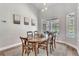 Elegant dining room with a large window overlooking the outdoor pool area, great for Gathering gatherings at 1610 River Birch Ave, Oviedo, FL 32765