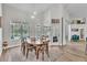 Bright dining room features wood floors, views of screened-in pool, and modern light fixtures at 1610 River Birch Ave, Oviedo, FL 32765