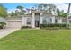 Charming single-story home with arched windows, well-manicured lawn and lush landscaping at 1610 River Birch Ave, Oviedo, FL 32765