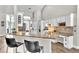 Modern kitchen with white cabinets, granite countertops, and a breakfast bar with seating at 1610 River Birch Ave, Oviedo, FL 32765