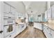 The chef's kitchen offers white appliances, stone backsplash, and opens to the dining area at 1610 River Birch Ave, Oviedo, FL 32765