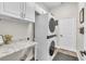Functional laundry room with stacked washer and dryer, complemented by ample countertop and cabinet space at 1610 River Birch Ave, Oviedo, FL 32765