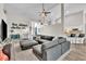 Open-concept living room featuring vaulted ceilings, hardwood floors, and stylish furnishings at 1610 River Birch Ave, Oviedo, FL 32765
