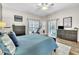 Comfortable main bedroom boasts plenty of natural light and an exercise bike, promoting a healthy lifestyle at 1610 River Birch Ave, Oviedo, FL 32765
