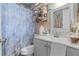 Bathroom featuring gray vanity, white toilet and floral shower curtain at 1828 Matterhorn Dr, Orlando, FL 32818