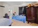 Bedroom featuring tile floors, a dark wood wardrobe, and a blue bedspread at 1828 Matterhorn Dr, Orlando, FL 32818