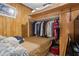 Small bedroom with a bed and closet under the bed, finished with wooden paneling at 1828 Matterhorn Dr, Orlando, FL 32818