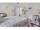 Bedroom with floral bedspread, framed wall art, and small antique wooden chair at 1828 Matterhorn Dr, Orlando, FL 32818