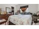 Bedroom with a floral comforter, dresser, and vintage mirror at 1828 Matterhorn Dr, Orlando, FL 32818