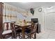 Cozy dining room featuring a wooden table set, decorative curtains and a hanging wall clock at 1828 Matterhorn Dr, Orlando, FL 32818