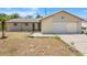 Charming single-story home featuring stucco walls, stone accents, and a two car garage at 1828 Matterhorn Dr, Orlando, FL 32818