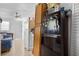 Additional kitchen featuring multiple refrigerators, tile floors, and adjacent living room at 1828 Matterhorn Dr, Orlando, FL 32818