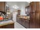 Traditional kitchen with brown cabinets, granite countertops, and stainless steel appliances at 1828 Matterhorn Dr, Orlando, FL 32818