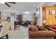 Cozy living room showcasing tile floors, a comfortable brown sofa, and wood paneling at 1828 Matterhorn Dr, Orlando, FL 32818