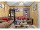 Cozy living room with wood paneling, comfortable sofas, and decorative displays at 1828 Matterhorn Dr, Orlando, FL 32818