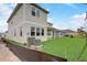 Beautifully landscaped backyard on a sunny day, featuring a home's exterior and a well-maintained lawn at 18964 Rawson St, Orlando, FL 32827