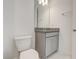 Bathroom with granite counter, vanity, toilet, and modern finishes at 18964 Rawson St, Orlando, FL 32827