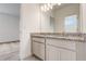 Bathroom vanity featuring granite countertops, with a view to the bright and airy bedroom at 18964 Rawson St, Orlando, FL 32827