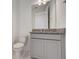 Bathroom with granite counter, vanity, toilet, and modern finishes at 18964 Rawson St, Orlando, FL 32827