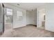 Comfortable bedroom with neutral carpet, access to the patio, and an ensuite bathroom at 18964 Rawson St, Orlando, FL 32827