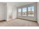 Bright bedroom with three windows, a neutral carpet, and an ensuite bathroom at 18964 Rawson St, Orlando, FL 32827