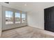 This bedroom features three large windows and neutral carpet at 18964 Rawson St, Orlando, FL 32827