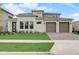 Inviting exterior of a modern two-story home with a manicured lawn and a three-car garage at 18964 Rawson St, Orlando, FL 32827