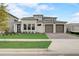 Inviting exterior of a modern two-story home with a manicured lawn and a three-car garage at 18964 Rawson St, Orlando, FL 32827