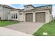 Stylish modern home with a well-maintained lawn and a three-car garage, showcasing its appealing curb appeal at 18964 Rawson St, Orlando, FL 32827