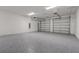 Spacious two car garage with gray epoxy flooring and two garage doors at 18964 Rawson St, Orlando, FL 32827