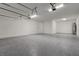 Spacious garage featuring epoxy flooring, white walls, and modern lighting at 18964 Rawson St, Orlando, FL 32827