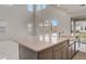Well-lit kitchen with an island, modern appliances, and convenient access to the backyard at 18964 Rawson St, Orlando, FL 32827