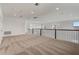 Spacious loft featuring plush carpeting, recessed lighting, and a decorative black metal railing at 18964 Rawson St, Orlando, FL 32827