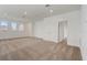 Open loft area with neutral carpet, bright lighting, and access to other rooms at 18964 Rawson St, Orlando, FL 32827