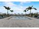 Upscale community pool features plentiful lounge seating, umbrellas, and palm trees at 18964 Rawson St, Orlando, FL 32827