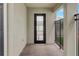 Inviting covered porch with a sleek door and a view of the well-maintained exterior at 18964 Rawson St, Orlando, FL 32827