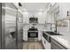 Modern kitchen featuring stainless steel appliances, white cabinetry, and a sleek black faucet, blending style and functionality at 2014 10Th Nw St, Winter Haven, FL 33881