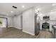 A modern kitchen with stainless steel appliances, white cabinets, and a seamless flow into the adjacent living area at 2014 10Th Nw St, Winter Haven, FL 33881