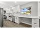 Stylish kitchen with white cabinets, stainless steel appliances, and a built-in desk area for added convenience at 2014 10Th Nw St, Winter Haven, FL 33881