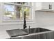 Close-up of a stylish kitchen sink with modern fixtures and a view of the outdoors at 2014 10Th Nw St, Winter Haven, FL 33881