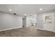 Open-concept living area with gray walls and wood flooring, showcasing a seamless flow at 2014 10Th Nw St, Winter Haven, FL 33881