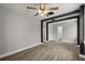 Open living room with gray walls, ceiling fan, and wood-look flooring at 2014 10Th Nw St, Winter Haven, FL 33881